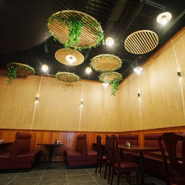 Fulin's Asian Cuisine Brentwood dining room with bamboo walls, red booths, and decorative ceiling panels.