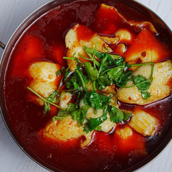 Fulin's Asian Cuisine's spicy fish fillet in red chili oil, garnished with fresh cilantro.